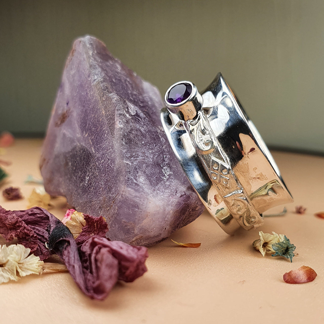 purple tourmaline spinner ring on raw gemstone