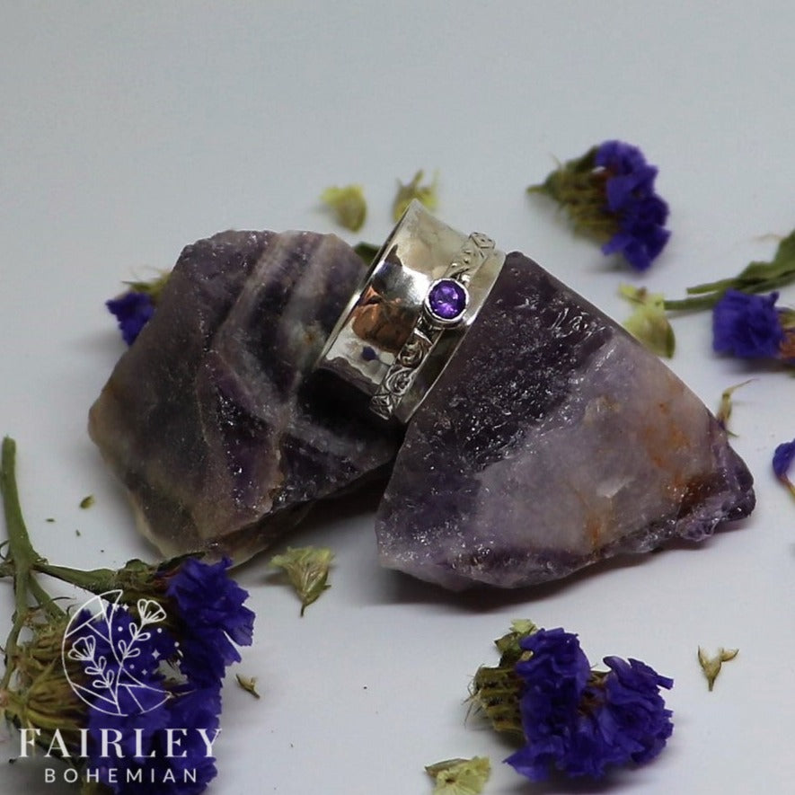 spinner ring with gemstone on raw crystals