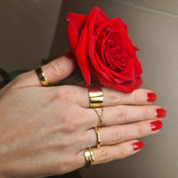 Thumbnail for model holding a rose with 5 gold adjustable rings on