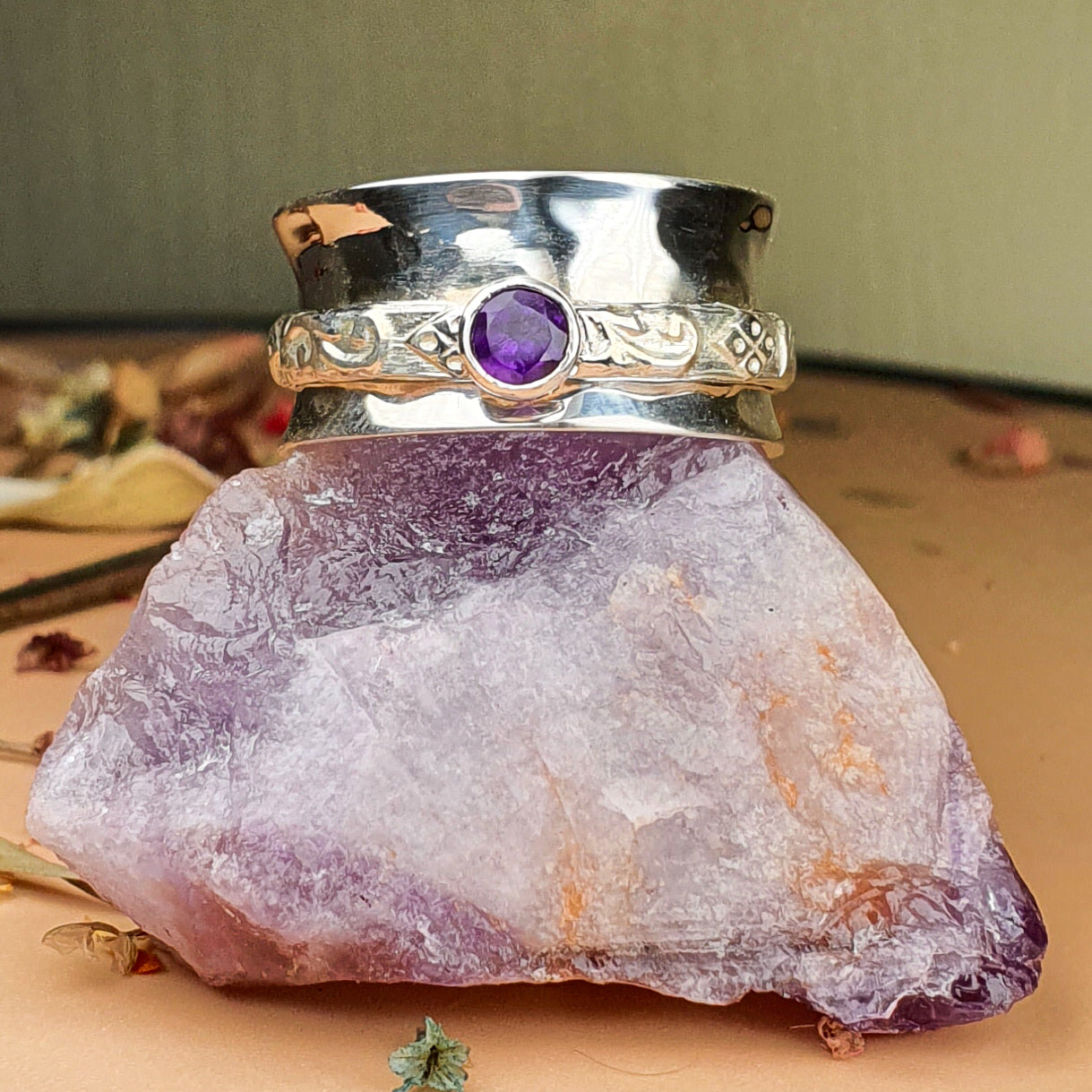 purple tourmaline spinner ring on raw gemstone