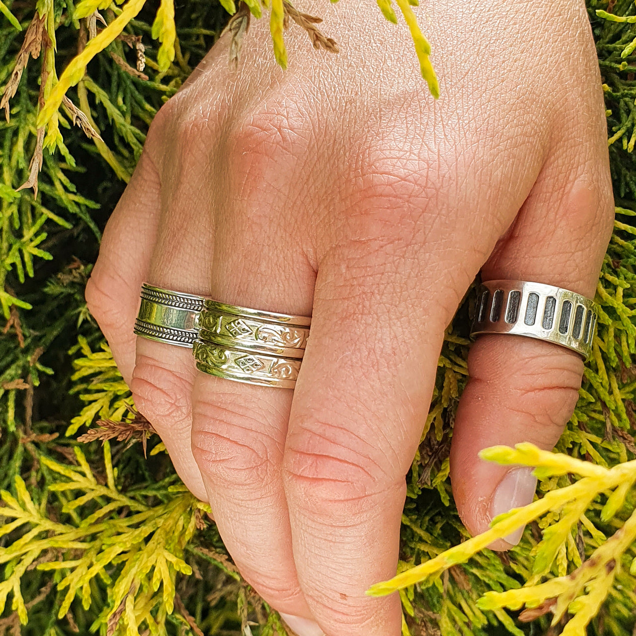 The Ultimate Spinner Ring with boho rings on hand model in nature