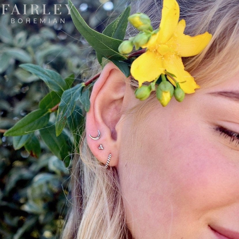 3 sets of bohemian earrings on a model with flowers